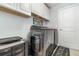 Laundry room with gray washer and dryer, white cabinets, and 'Laundry' mat at 186 Nw 44Th St, Ocala, FL 34475