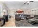Open-concept living room and kitchen featuring a large sectional, ceiling fan, and abundant natural light at 186 Nw 44Th St, Ocala, FL 34475