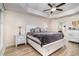 Spacious main bedroom boasts a tray ceiling, ceiling fan, and plenty of natural light at 186 Nw 44Th St, Ocala, FL 34475