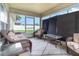 Enclosed sun room with wicker furniture, glass tables, and screens for privacy at 186 Nw 44Th St, Ocala, FL 34475