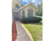 Beautiful front entrance with brick pathway, mulch landscaping, large window, and a storm door at 1980 Aquarius Ct, Oviedo, FL 32766