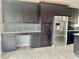 Modern kitchen featuring granite countertops, stainless steel appliances, and a built-in desk area at 1980 Aquarius Ct, Oviedo, FL 32766