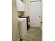 Functional laundry room with modern washer and dryer, overhead storage cabinets, and neutral flooring at 1980 Aquarius Ct, Oviedo, FL 32766