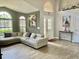 Bright and airy living room with tile floors, large windows, and stylish décor, creating a welcoming atmosphere at 1980 Aquarius Ct, Oviedo, FL 32766