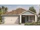 Charming single-story home featuring a two-car garage and a beautifully landscaped front yard at 215 Taylor Groves St, Lake Wales, FL 33898