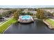 Aerial shot showcasing a luxurious community pool and clubhouse with a scenic lakeside deck and amenities at 2204 San Vittorino Cir # 102, Kissimmee, FL 34741