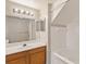 Well-lit bathroom featuring a tub/shower combo and a vanity with ample counter space and storage at 2204 San Vittorino Cir # 102, Kissimmee, FL 34741