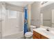 Clean bathroom with a tub and shower, featuring a blue shower curtain and a vanity at 2204 San Vittorino Cir # 102, Kissimmee, FL 34741