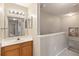 Bathroom featuring a vanity with a mirror, staircase with carpeted steps, and a hallway view at 2204 San Vittorino Cir # 102, Kissimmee, FL 34741