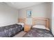 Charming bedroom with twin beds, ceiling fan, and natural light from the window at 2204 San Vittorino Cir # 102, Kissimmee, FL 34741