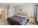 Inviting bedroom featuring a wooden bed frame, tiled floors, and a door leading to the bathroom at 2204 San Vittorino Cir # 102, Kissimmee, FL 34741