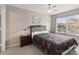 Well-lit bedroom features a large bed, ceiling fan and a window at 2204 San Vittorino Cir # 102, Kissimmee, FL 34741