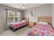 Bedroom with two wooden beds, ceiling fan, and a window overlooking the neighborhood at 2204 San Vittorino Cir # 102, Kissimmee, FL 34741