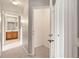 Hallway view leading to a bathroom with wood vanity and a doorway to storage at 2204 San Vittorino Cir # 102, Kissimmee, FL 34741