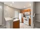 Well-lit kitchen featuring light wood cabinets, white appliances, and a functional breakfast bar that adjoins the living space at 2204 San Vittorino Cir # 102, Kissimmee, FL 34741