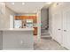 Functional kitchen featuring light wood cabinets, white appliances, and a breakfast bar open to the adjacent living space at 2204 San Vittorino Cir # 102, Kissimmee, FL 34741