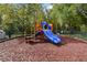Bright and colorful community playground with mulch ground cover and a slide offers fun for of all ages at 2204 San Vittorino Cir # 102, Kissimmee, FL 34741