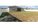 Spacious backyard featuring grass, a partial fence, and an outdoor patio at 2249 Palmetum Loop, Apopka, FL 32712