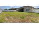 Spacious backyard with grass, a partial fence, and an outdoor patio at 2249 Palmetum Loop, Apopka, FL 32712