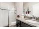 Bathroom featuring a vanity with granite countertop, a glass door walk-in shower, and white tiled walls at 2249 Palmetum Loop, Apopka, FL 32712