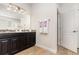 Bathroom with double vanity, dark wood cabinets, granite countertops and tile flooring at 2249 Palmetum Loop, Apopka, FL 32712