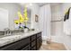 Bathroom featuring double sink vanity with granite countertop and wood-look tile floors at 2249 Palmetum Loop, Apopka, FL 32712