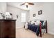 Bedroom with a daybed featuring an ornate metal frame, soft pillows, and carpeted floors at 2249 Palmetum Loop, Apopka, FL 32712