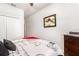 Bedroom featuring a queen bed, a large window, and a dark wood dresser at 2249 Palmetum Loop, Apopka, FL 32712