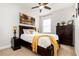 Bright bedroom featuring a dark wood bed frame with a white comforter and yellow accents at 2249 Palmetum Loop, Apopka, FL 32712
