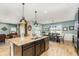 Open concept kitchen with stainless steel appliances, granite countertops and island at 2249 Palmetum Loop, Apopka, FL 32712