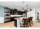 Kitchen view highlighting the stainless steel appliances, granite counters and large island with seating at 2249 Palmetum Loop, Apopka, FL 32712