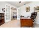 Well-lit home office featuring glass french doors, a spacious desk, and a comfortable leather chair at 2249 Palmetum Loop, Apopka, FL 32712