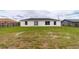Large backyard featuring a well-maintained lawn and a new, modern construction at 2486 Ainsworth Ave, Deltona, FL 32738
