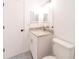 Clean bathroom with granite vanity, decorative floor tiles, and modern fixtures at 2486 Ainsworth Ave, Deltona, FL 32738