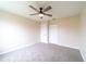 Cozy bedroom with carpeted flooring, ceiling fan, and closet space at 2486 Ainsworth Ave, Deltona, FL 32738