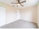 Cozy bedroom featuring plush carpet, ceiling fan, and closet at 2486 Ainsworth Ave, Deltona, FL 32738