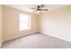Comfortable bedroom with a fan, neutral walls and carpeting, and natural light at 2486 Ainsworth Ave, Deltona, FL 32738