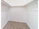 Walk in closet with carpet and white walls and hardware at 2486 Ainsworth Ave, Deltona, FL 32738