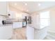 Modern kitchen with white cabinets, a tile backsplash, and stainless steel appliances at 2486 Ainsworth Ave, Deltona, FL 32738