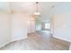 Open-concept living area with wood-look flooring and contemporary lighting at 2486 Ainsworth Ave, Deltona, FL 32738