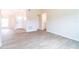 Bright living room features wood-look tile flooring and a neutral color palette at 2486 Ainsworth Ave, Deltona, FL 32738