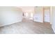 Spacious living room with wood-look flooring, neutral walls, and contemporary fixtures at 2486 Ainsworth Ave, Deltona, FL 32738