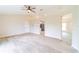 Open living room featuring neutral walls, ceiling fan, and light wood-look tile flooring at 2486 Ainsworth Ave, Deltona, FL 32738