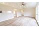 Spacious living room featuring tile flooring, ceiling fan, and views of the kitchen and dining area at 2486 Ainsworth Ave, Deltona, FL 32738