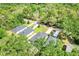 Aerial view of homes surrounded by lush greenery, showcasing neighborhood layout at 25106 Quaker Ridge Ave, Sorrento, FL 32776