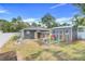 Inviting backyard with play area, lush lawn, and storage shed offering a perfect outdoor retreat at 25106 Quaker Ridge Ave, Sorrento, FL 32776