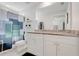 Bathroom featuring double sinks, white cabinetry, and a decorative shower curtain at 25106 Quaker Ridge Ave, Sorrento, FL 32776