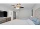 Bedroom with large bed, fan, and tv at 25106 Quaker Ridge Ave, Sorrento, FL 32776