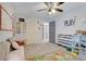Spacious bedroom with neutral tones, playful decor and wall-mounted toy car display at 25106 Quaker Ridge Ave, Sorrento, FL 32776