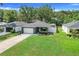 Beautiful single-story home featuring green lawn, driveway, and landscaped garden at 25106 Quaker Ridge Ave, Sorrento, FL 32776